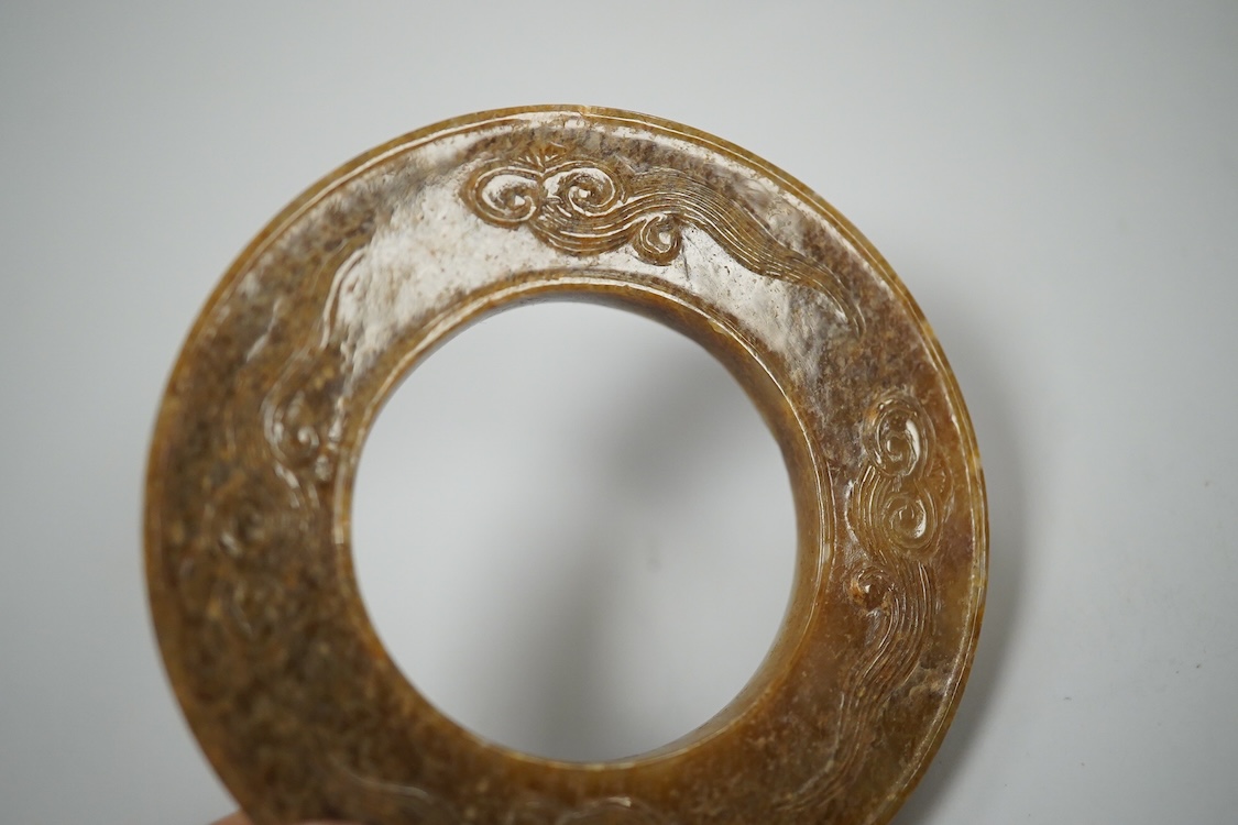 A Chinese russet jade dragon disc, 5.5cm diameter